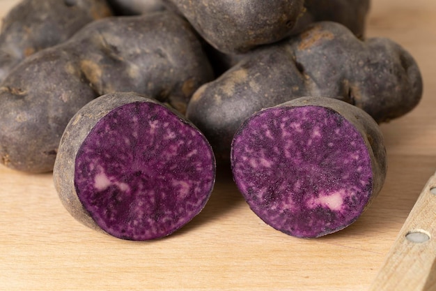 Homegrown organic purple Vitelotte potato in half close up