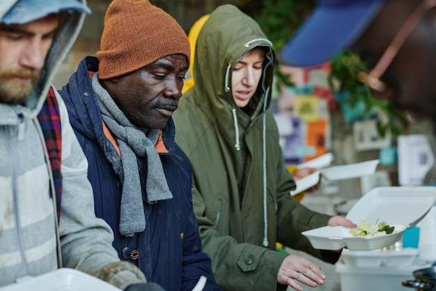 Homeless people eating free food