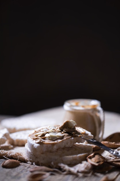 Homemade almond butter on a slice of rice crispbread. Closeup