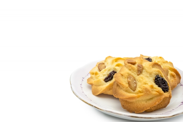 Homemade almond and rum raisin cookies on plate isolate on white background