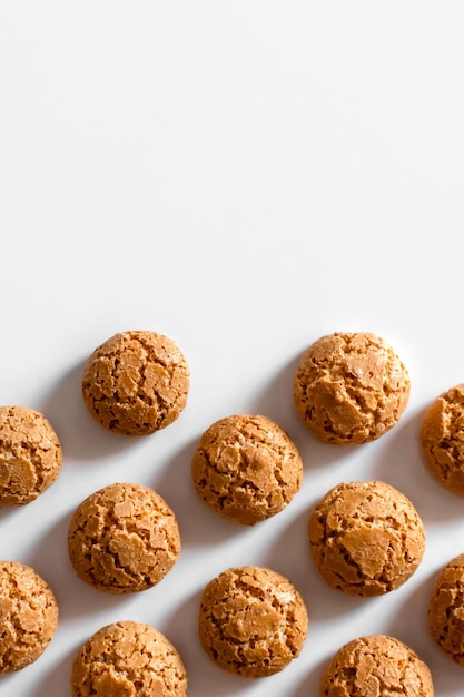 Homemade amaretti cookies with cracks on a light background copy space vertical