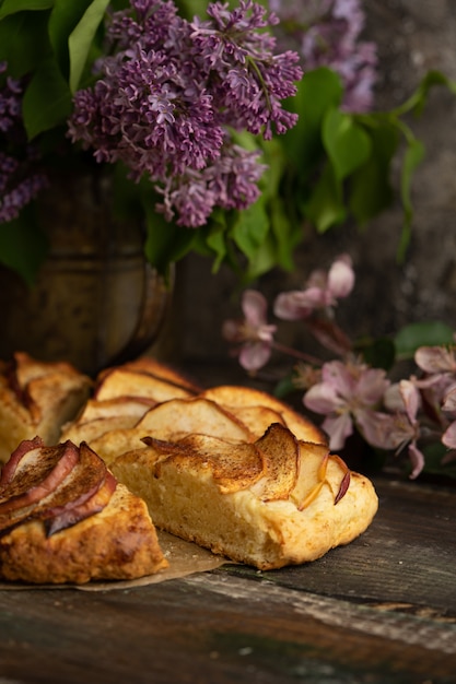 homemade apple cinnamon scones with lilac flowers and apple blooming branches