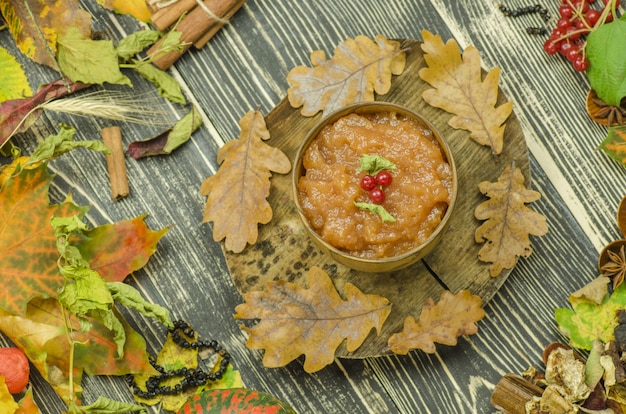 Homemade apple jam on a wooden background