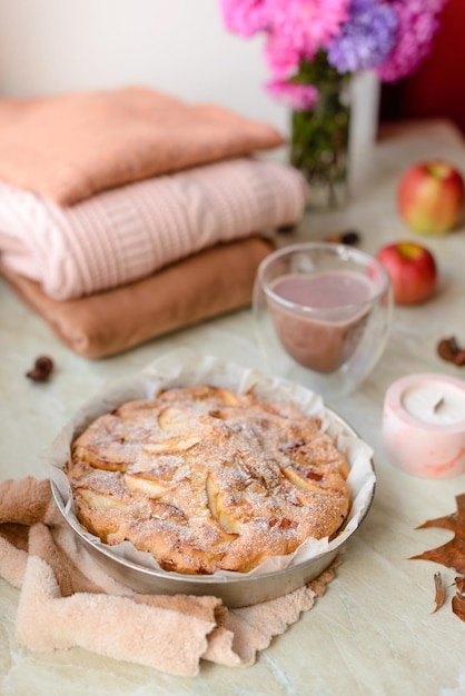 Homemade apple pie on a white background near the window closeup and copy space