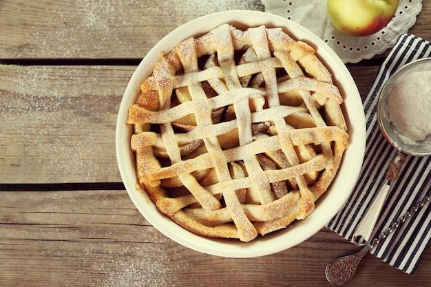 Homemade apple pie on wooden background