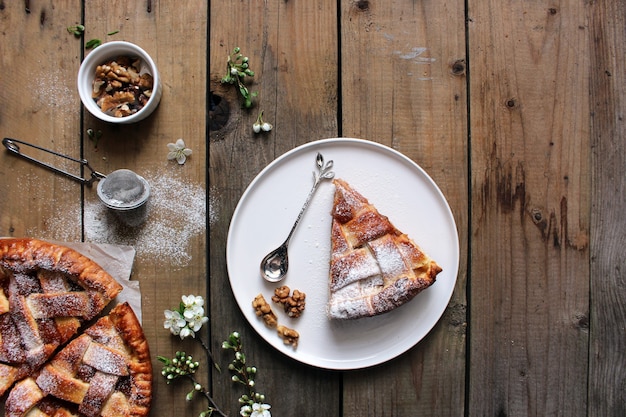 Homemade Apple Pies on rustic background, top view, copy space. Classic autumn Thanksgiving pastry dessert - organic apple pie.