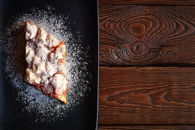 Homemade apricot pie Top view slice of rustic hot sweet cake sprinkle with powdered sugar