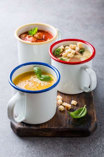 Homemade assorted soups with ingredients