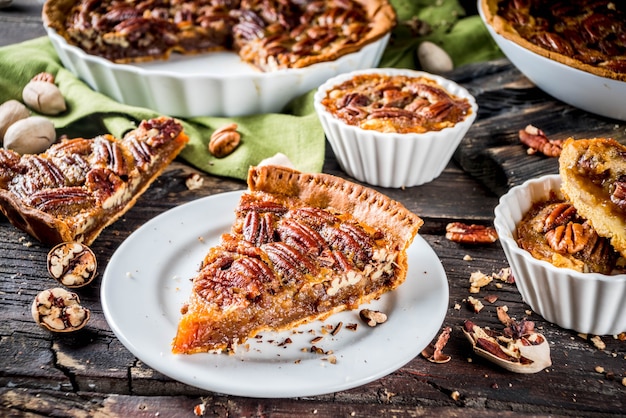 Homemade autumn pecan pie on wooden rustic background, Traditional fall and winter, thanksgiving american nut cake,