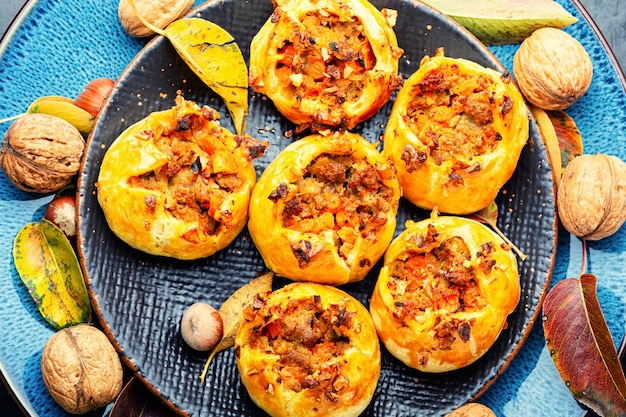 Homemade autumnal buns stuffed with pumpkin and meat