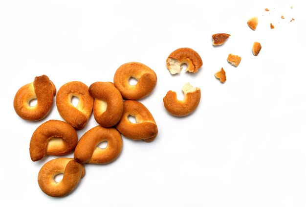 Homemade bagel isolated on white background. Trajectory or flight of broken parts and crumbs top view