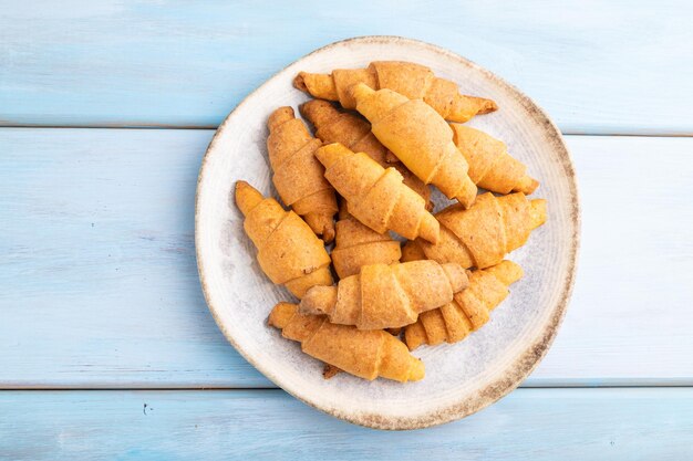 Homemade bagel roll on a blue wooden background and top view close up