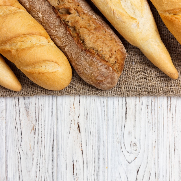 Homemade baguettes on wooden table