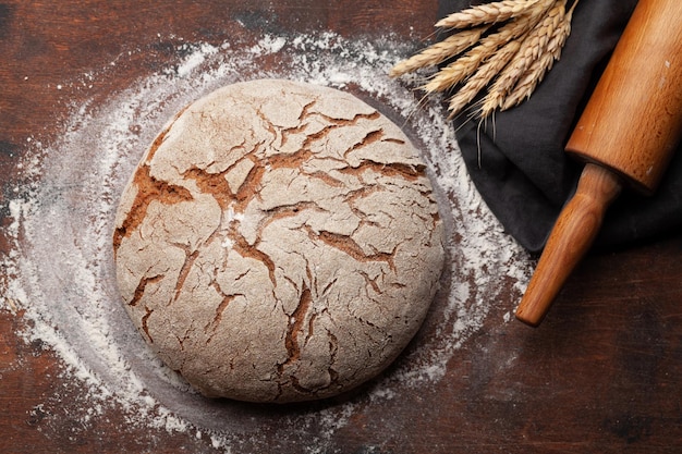 Homemade baked bread on wooden table Top view flat lay