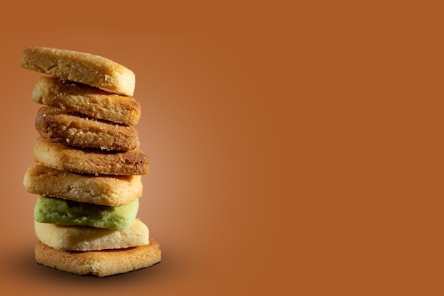 homemade baked dough or square cookies, stacked over each other on brown background with copy space