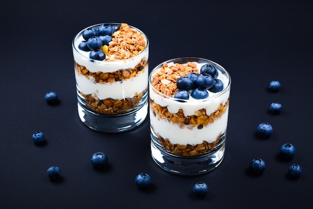 Homemade baked granola with yogurt and blueberries in a glass