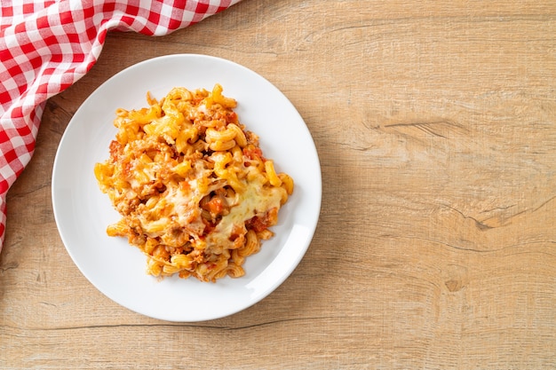 homemade baked macaroni bolognese with cheese - Italian food style