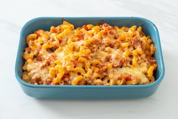 homemade baked macaroni bolognese with cheese - Italian food style