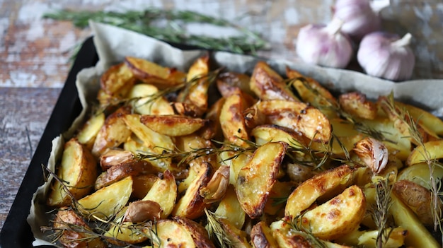 Homemade baked rustic potato with garlic and rosemary.