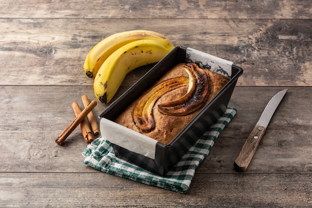 Homemade banana bread on rustic wooden table.