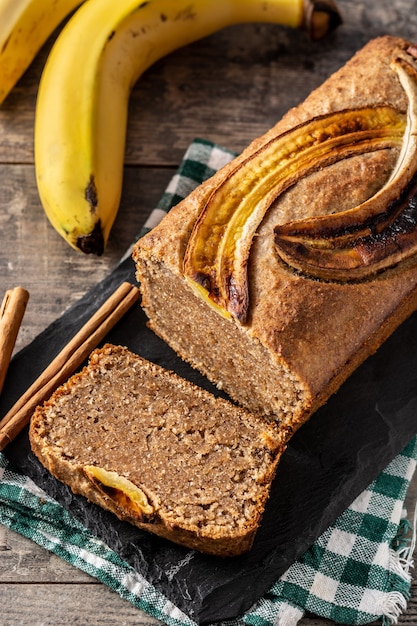 Homemade banana bread on rustic wooden table.