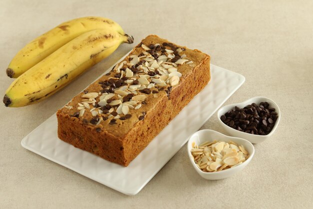 Homemade Banana cake covered with almond slices and chocolate drops Cut into Slices