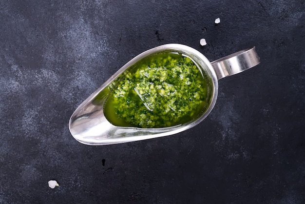 Homemade basil pesto with parsley in bowl. 