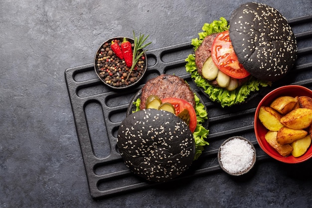 Homemade beef burgers with black buns