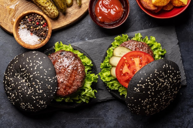 Homemade beef burgers with black buns