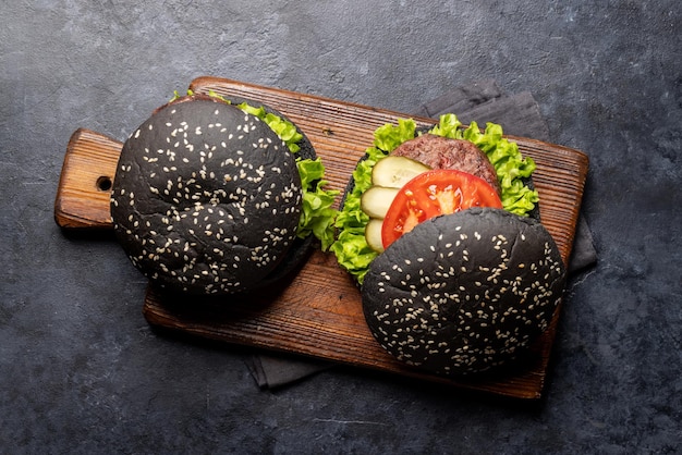 Homemade beef burgers with black buns