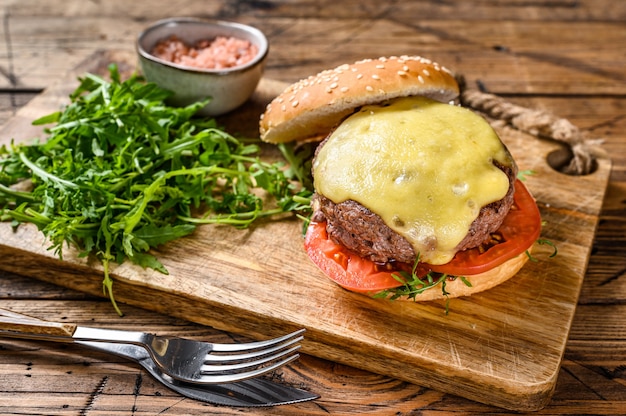 homemade beef burgers with cheese, greens, and onion