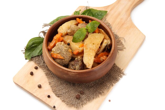 Homemade beef stir fry with vegetables in color bowl on wooden board isolated on white