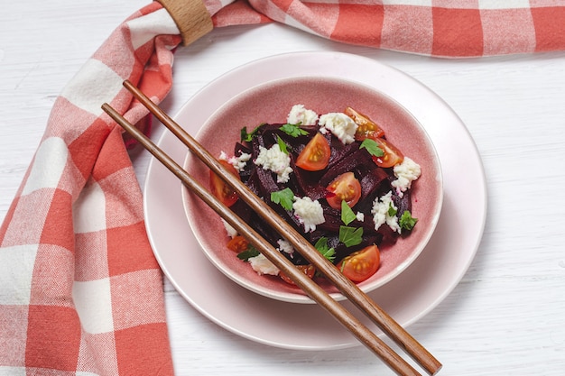 Homemade Beet Salad in bowl with Walnuts, Mozzarella, Parsley, and Cherry Tomatoes. Vegan food concept