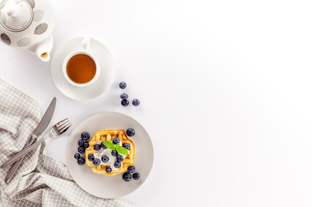 Homemade belgian waffles on served table on white