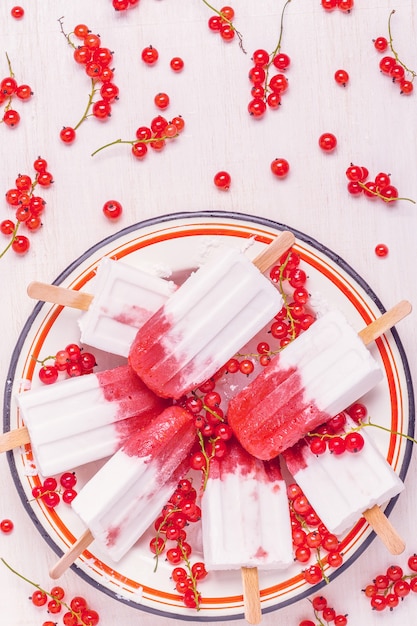 Photo homemade berries and coconut milk popsicles, top view.