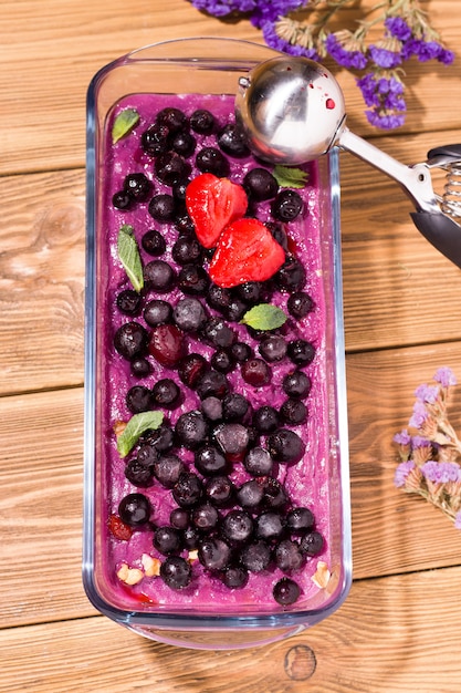 Homemade berry sorbet on a wooden space.