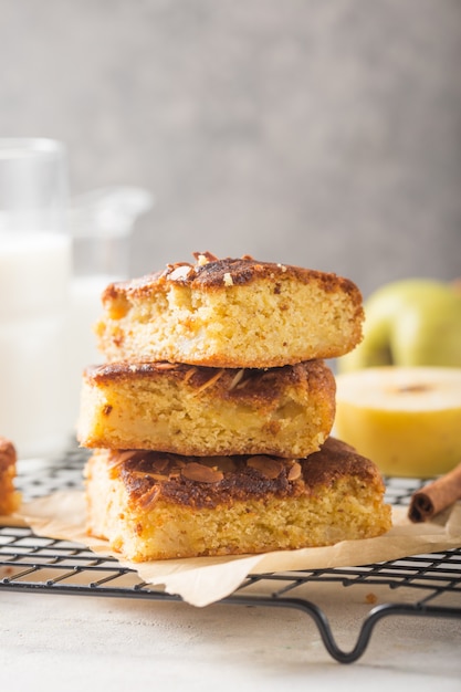 Homemade blondie (blonde) brownies apple cake square slices with glass of milk