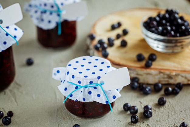 Homemade blueberry jam in a jar and fresh blueberries.Health 