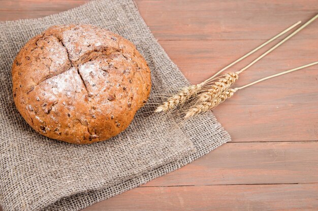 Homemade bread on a napkin with spikelets Horizontal orientationPlace for a copy space