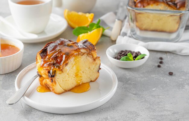 Homemade bread pudding with chocolate chips on a gray concrete background Selective focus copy space