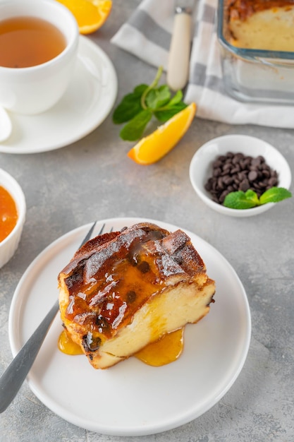 Homemade bread pudding with chocolate chips on a gray concrete background Selective focus copy space