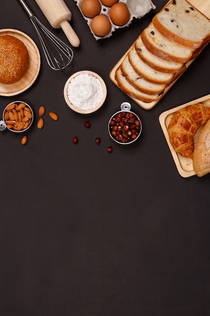 Homemade breads ingredients on black background