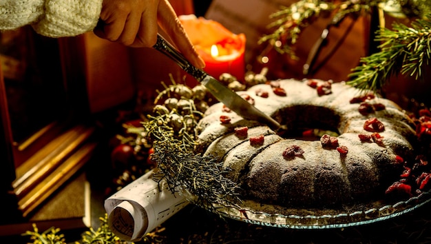 homemade Bundt cake decorated with sugar icing and berries in Christmas mood Dessert called Kuglof in some Countries