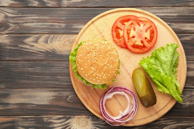 Homemade burger ingredients arranged on wooden. Top view