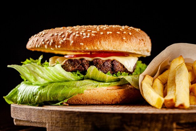 Homemade burger with beef chop, tomato, lettuce and sweet and sour sauce