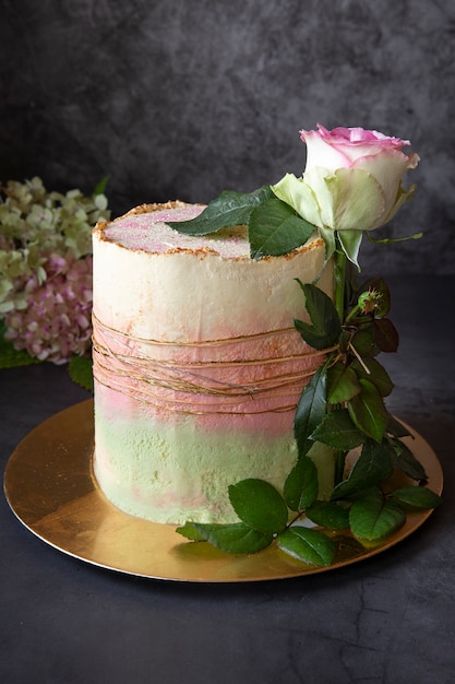 Homemade cake.The birthday cake is decorated with a live rose.