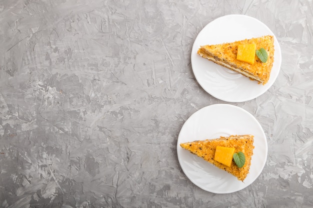 Homemade cake with persimmon and pumpkin on a gray concrete background. top view, copy space.