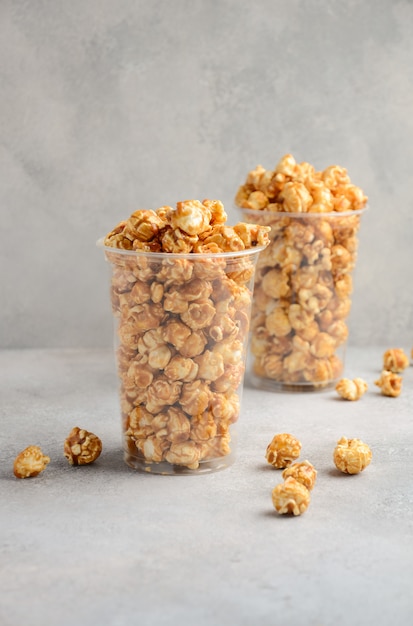 Homemade Caramel Popcorn on a gray concrete.