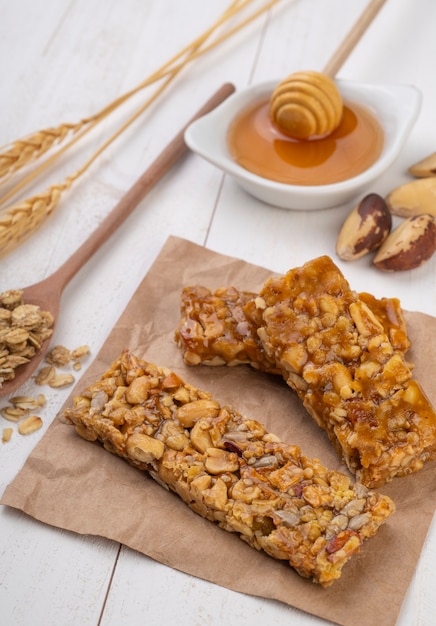 Homemade cereal bars with nuts, muesli, honey and copy space.