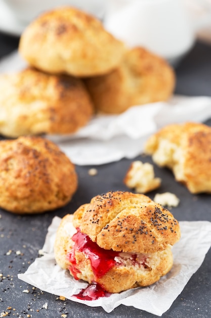 Homemade cheese buns with poppy seeds and berry jam